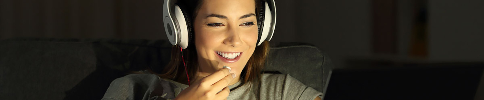 Photo of person wearing headphones and eating
